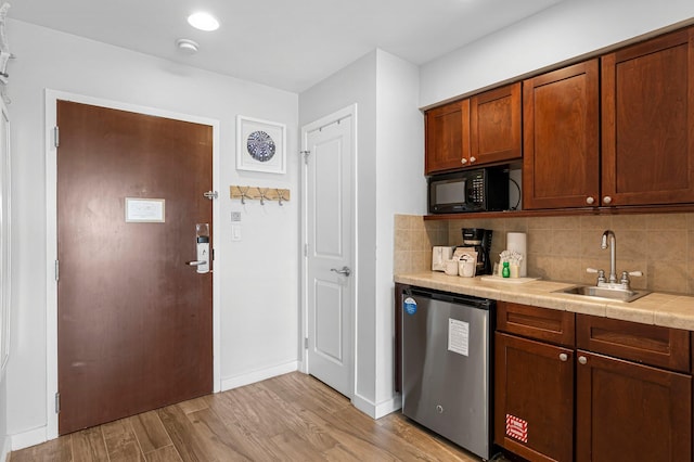 5000 S Sandestin Blvd Unit 6806, Sandestin, FL 32550 - kitchen featuring black microwave, backsplash, fridge, tile countertops, and a sink