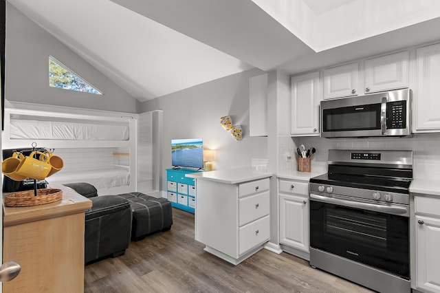 496 Linkside Dr, Miramar Beach, FL 32550 - kitchen with open floor plan, appliances with stainless steel finishes, decorative backsplash, and white cabinetry