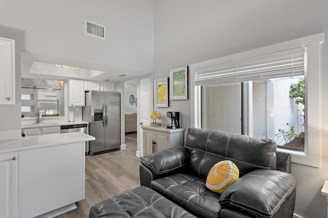 496 Linkside Dr, Miramar Beach, FL 32550 - living area with a high ceiling, light wood finished floors, and visible vents