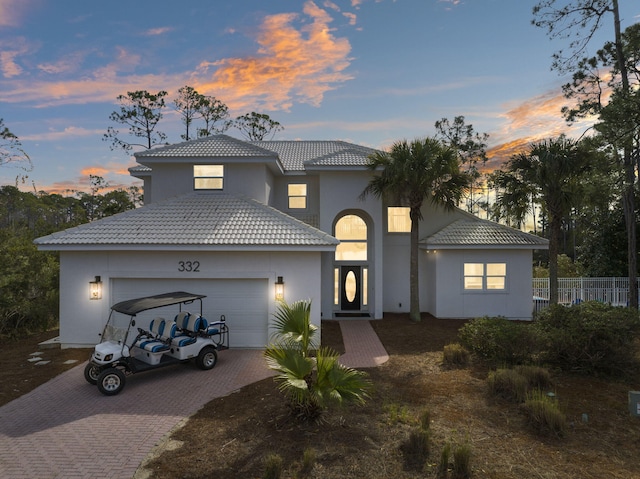 332 Somerset Bridge Rd, Santa Rosa Beach, FL 32459 - traditional-style house with stucco siding, decorative driveway, fence, a tile roof, and an attached garage