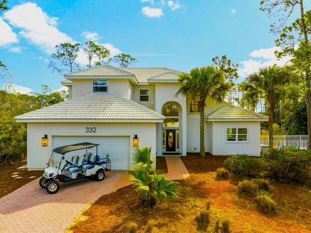 332 Somerset Bridge Rd, Santa Rosa Beach, FL 32459 - traditional-style house featuring stucco siding, decorative driveway, a garage, a tiled roof, and fence