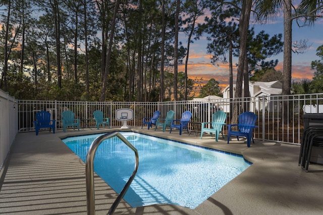 332 Somerset Bridge Rd, Santa Rosa Beach, FL 32459 - pool at dusk featuring a patio area and a community pool