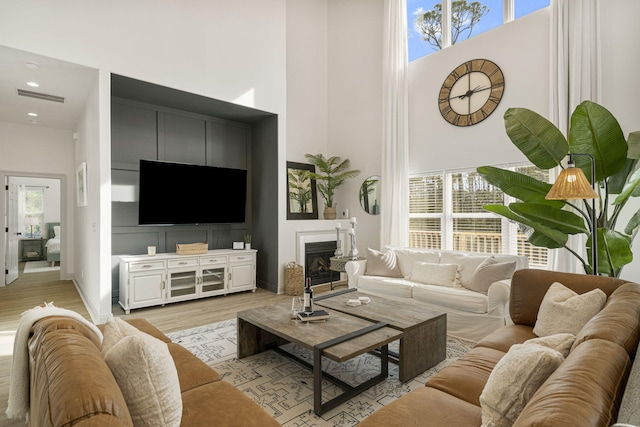 332 Somerset Bridge Rd, Santa Rosa Beach, FL 32459 - living room with visible vents, light wood finished floors, plenty of natural light, and a high ceiling