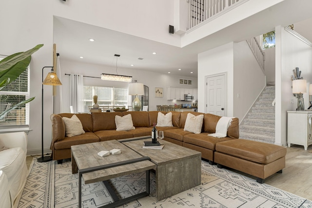 332 Somerset Bridge Rd, Santa Rosa Beach, FL 32459 - living room featuring light wood finished floors, a towering ceiling, recessed lighting, and stairs