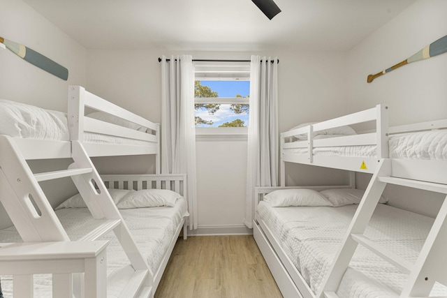 332 Somerset Bridge Rd, Santa Rosa Beach, FL 32459 - bedroom with baseboards, a ceiling fan, and wood finished floors