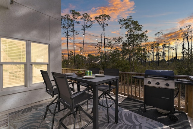 332 Somerset Bridge Rd, Santa Rosa Beach, FL 32459 - deck at dusk with a grill and outdoor dining area