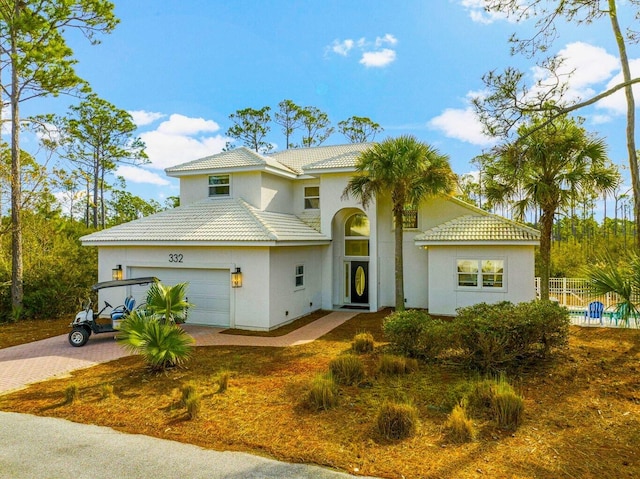 332 Somerset Bridge Rd, Santa Rosa Beach, FL 32459 - view of front of home featuring stucco siding, decorative driveway, a garage, a tiled roof, and fence