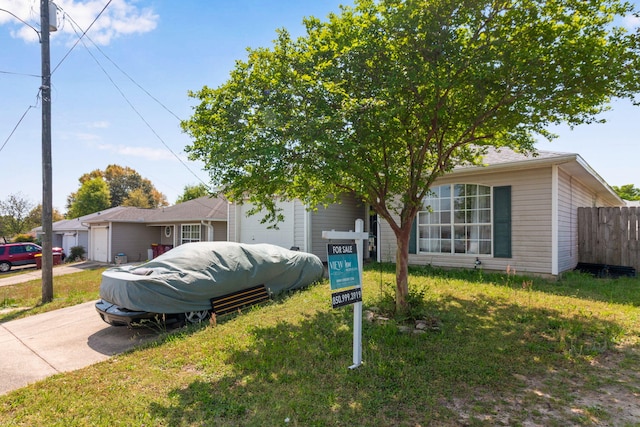 322 Apple Dr, Crestview, FL 32536 - view of front of home with an attached garage, fence, and concrete driveway