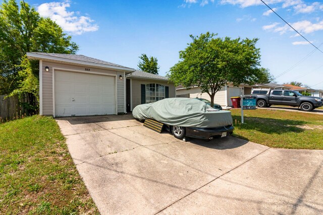 322 Apple Dr, Crestview, FL 32536 - ranch-style house featuring a front yard, fence, an attached garage, a shingled roof, and driveway