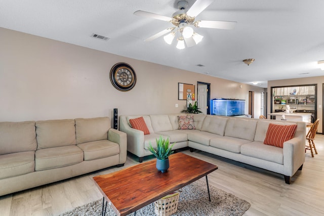 322 Apple Dr, Crestview, FL 32536 - living room with visible vents, light wood-style flooring, and a ceiling fan