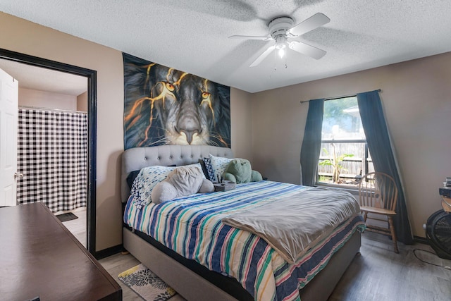 322 Apple Dr, Crestview, FL 32536 - bedroom featuring light wood-style flooring, a textured ceiling, baseboards, and a ceiling fan