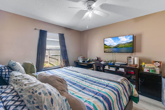 322 Apple Dr, Crestview, FL 32536 - bedroom featuring a textured ceiling, wood finished floors, and a ceiling fan