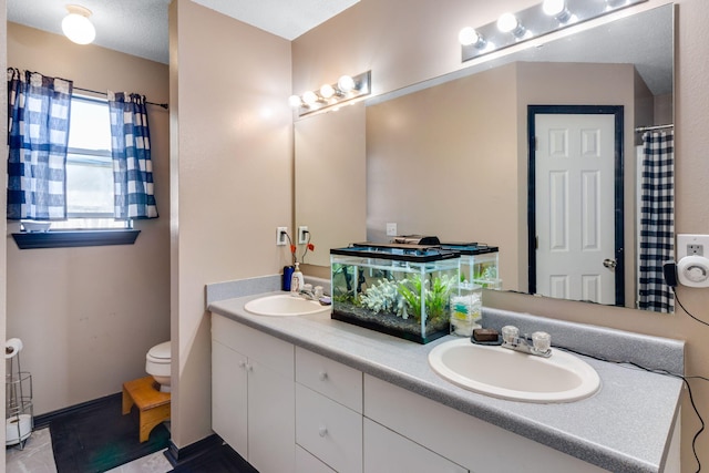 322 Apple Dr, Crestview, FL 32536 - bathroom with a sink, toilet, and double vanity