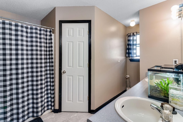 322 Apple Dr, Crestview, FL 32536 - full bath featuring a textured ceiling, a shower with shower curtain, marble finish floor, and a sink