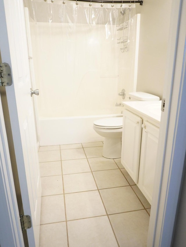 full bath with tile patterned floors, toilet, shower / bath combo, and vanity
