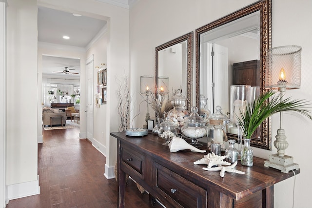 hallway with crown molding, baseboards, and dark wood-style flooring