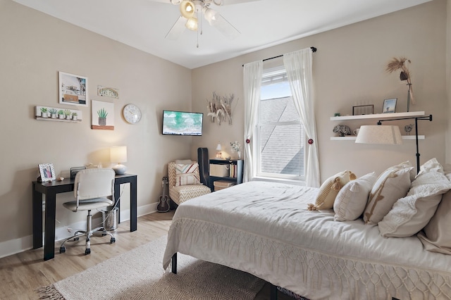 bedroom with wood finished floors and baseboards