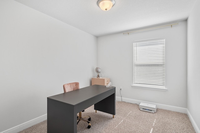 carpeted office space featuring baseboards