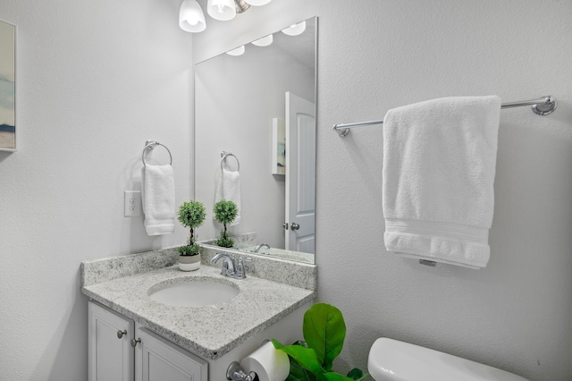 bathroom with toilet and vanity