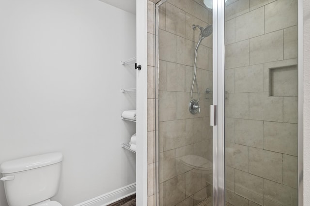 full bath featuring toilet and a stall shower