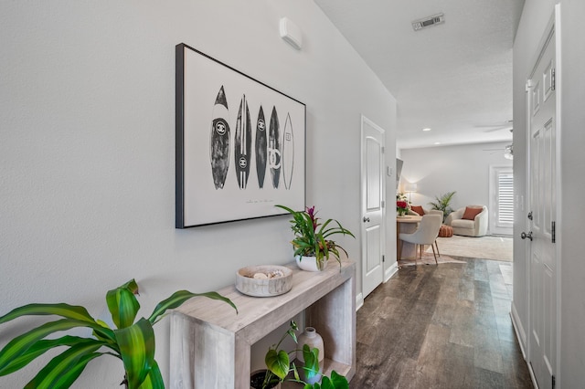 hall featuring visible vents, baseboards, recessed lighting, and wood finished floors