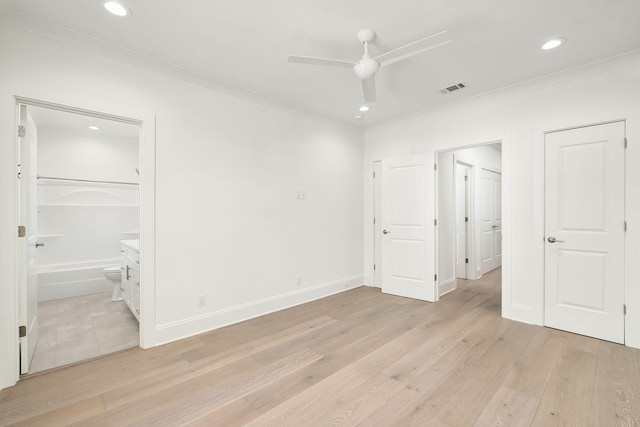 unfurnished bedroom with ornamental molding, visible vents, ensuite bathroom, and light wood-style flooring