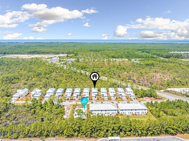 birds eye view of property featuring a view of trees