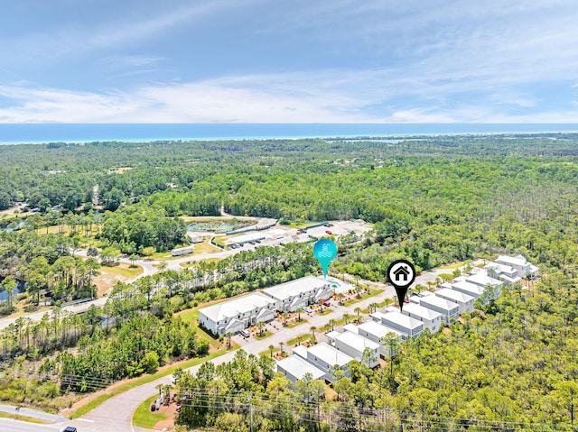 drone / aerial view featuring a forest view