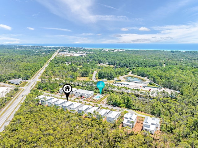 bird's eye view with a wooded view