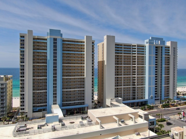 view of building exterior featuring a water view and a city view