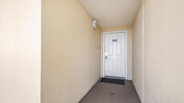 property entrance with stucco siding