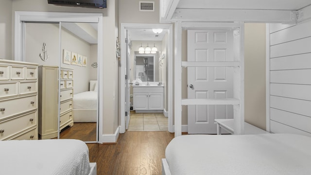 bedroom featuring baseboards, visible vents, a closet, and dark wood-type flooring