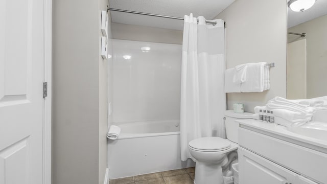 full bath featuring tile patterned floors, toilet, vanity, shower / tub combo with curtain, and a textured ceiling