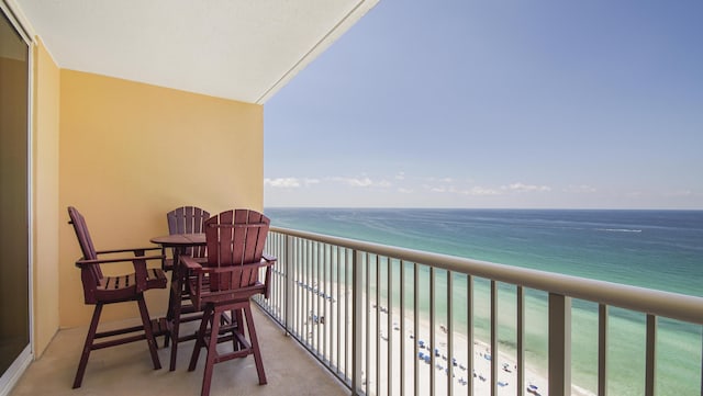 balcony with a view of the beach and a water view