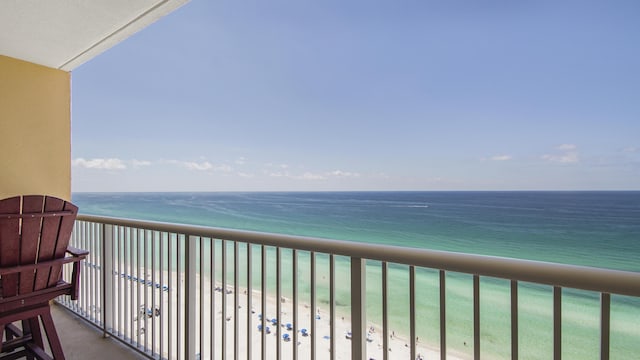 balcony with a view of the beach and a water view