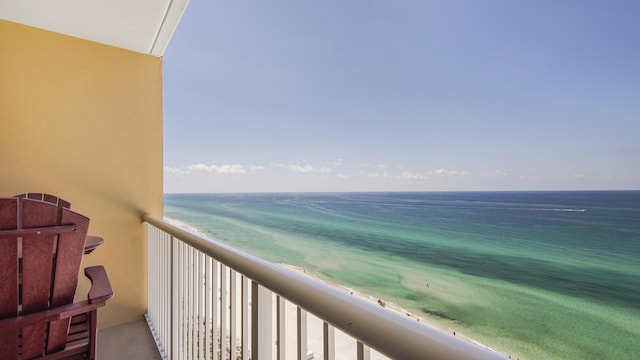 balcony featuring a beach view and a water view