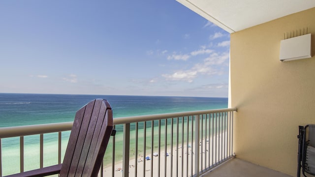 balcony featuring a beach view and a water view