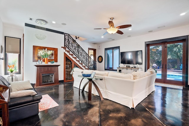 100 Vista Blfs, Destin, FL 32541 - living room with a glass covered fireplace, recessed lighting, stairway, and french doors