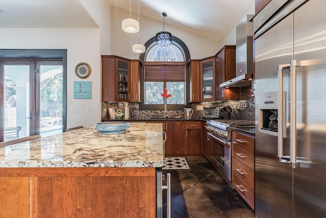 100 Vista Blfs, Destin, FL 32541 - kitchen featuring tasteful backsplash, premium appliances, a sink, wall chimney range hood, and vaulted ceiling