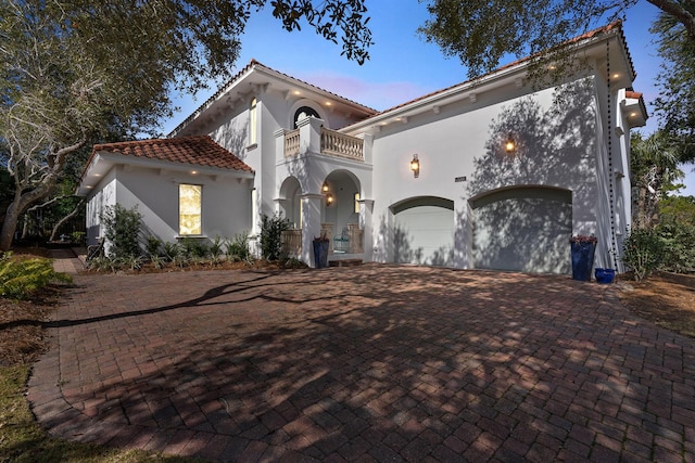 100 Vista Blfs, Destin, FL 32541 - mediterranean / spanish house featuring a balcony, a tiled roof, decorative driveway, and stucco siding