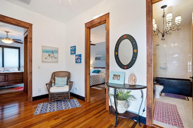 100 Vista Blfs, Destin, FL 32541 - interior space featuring baseboards, wood finished floors, and ceiling fan with notable chandelier