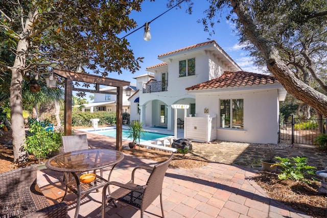 100 Vista Blfs, Destin, FL 32541 - back of house featuring a patio, a balcony, stucco siding, a tile roof, and fence