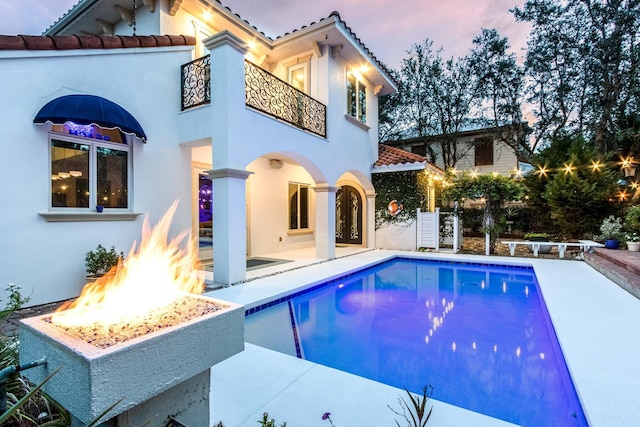 100 Vista Blfs, Destin, FL 32541 - back of property featuring an outdoor fire pit, a tiled roof, stucco siding, and a balcony
