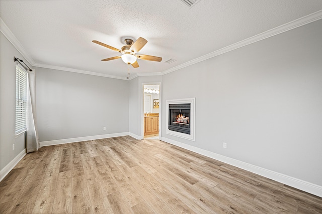 119 Long Pointe Dr, Mary Esther, FL 32569 - unfurnished room with ceiling fan, a textured ceiling, light wood finished floors, crown molding, and a lit fireplace