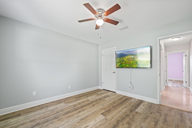 119 Long Pointe Dr, Mary Esther, FL 32569 - unfurnished bedroom featuring wood finished floors, a textured ceiling, and a ceiling fan