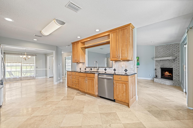 119 Long Pointe Dr, Mary Esther, FL 32569 - kitchen with stainless steel appliances, a chandelier, a fireplace, backsplash, and open floor plan
