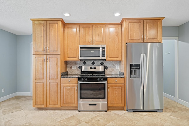 119 Long Pointe Dr, Mary Esther, FL 32569 - kitchen with stainless steel appliances, decorative backsplash, dark stone counters, recessed lighting, and a textured ceiling