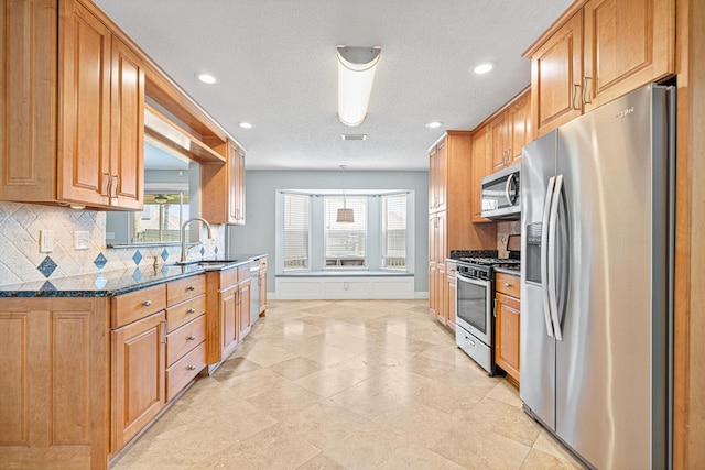 119 Long Pointe Dr, Mary Esther, FL 32569 - kitchen with appliances with stainless steel finishes, backsplash, recessed lighting, dark stone counters, and decorative light fixtures