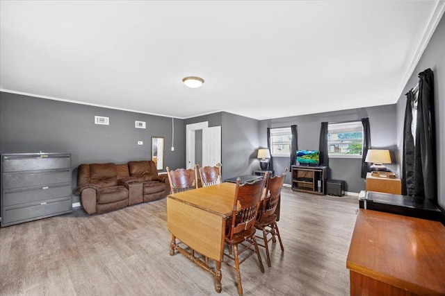 706 Mary Ave, Fort Walton Beach, FL 32547 - dining room featuring ornamental molding, wood finished floors, visible vents, and baseboards
