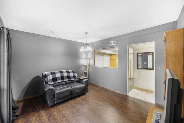 706 Mary Ave, Fort Walton Beach, FL 32547 - living area with visible vents, wood finished floors, and an inviting chandelier